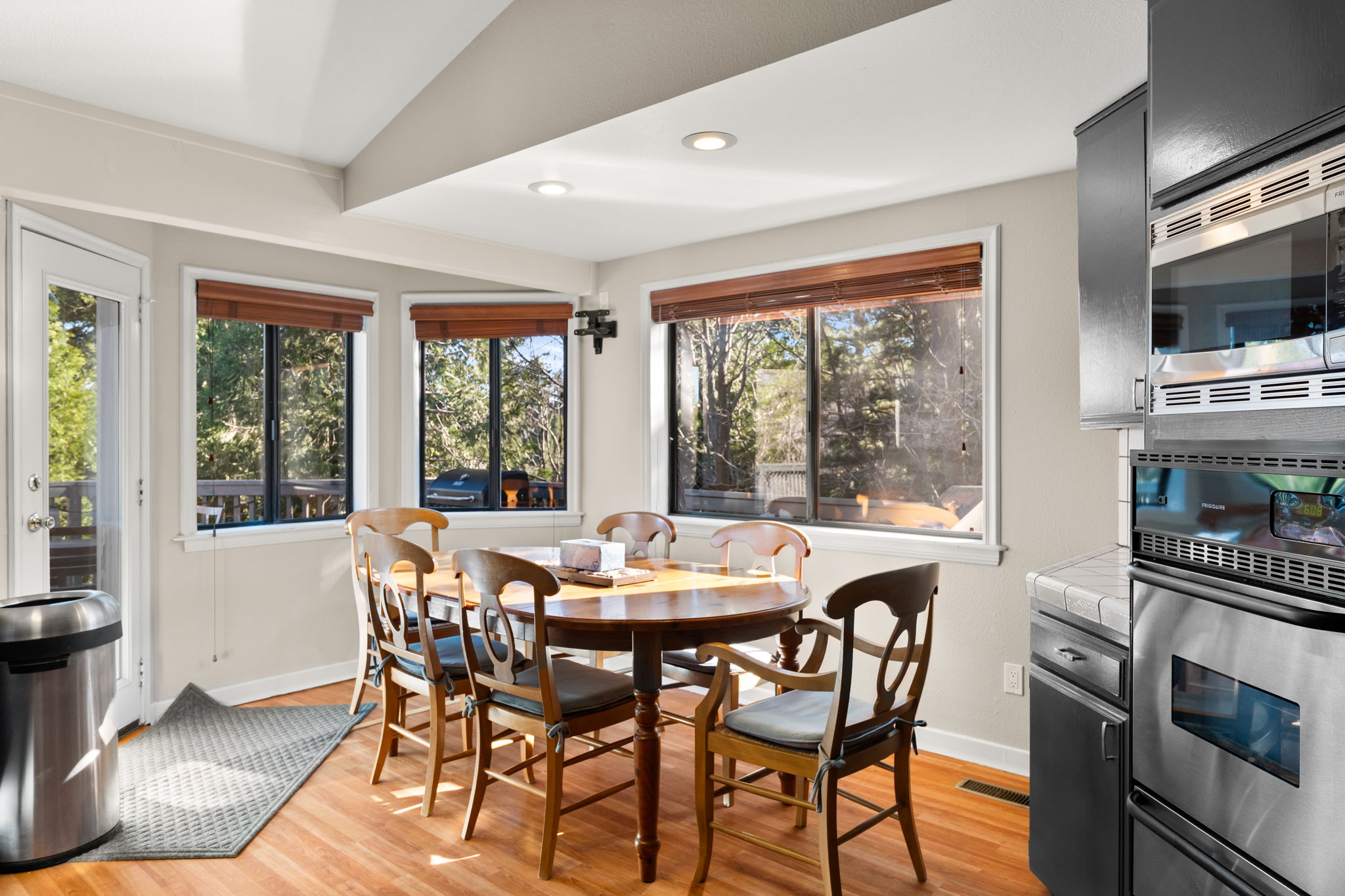 Bright kitchen and dining area surrounded by windows